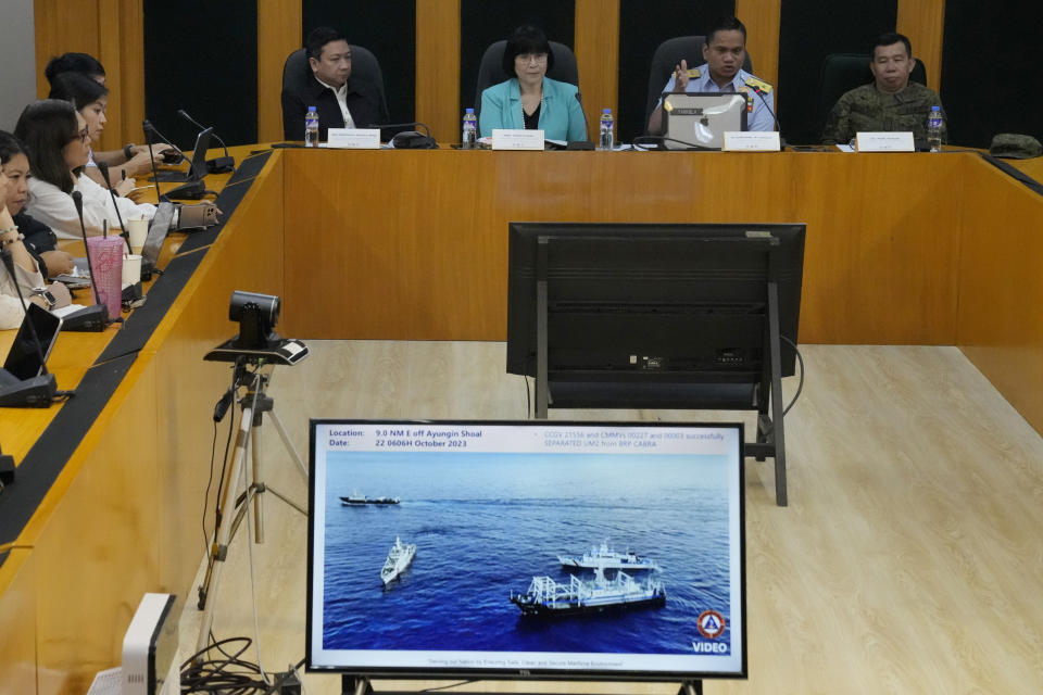 Philippine Coast Guard spokesperson, Commodore Jay Tarriela, second from left, shows reporters a video of an incident involving Chinese coast guard ship and Chinese militia boats blocking a Philippine coast guard ship during a press conference In Quezon City, Philippines on Monday, Oct. 23, 2023. A Chinese coast guard ship and an accompanying vessel rammed a Philippine coast guard ship and a military-run supply boat Sunday off a contested shoal, Philippine officials said, in an encounter that heightened fears of an armed conflict in the disputed South China Sea. (AP Photo/Aaron Favila)