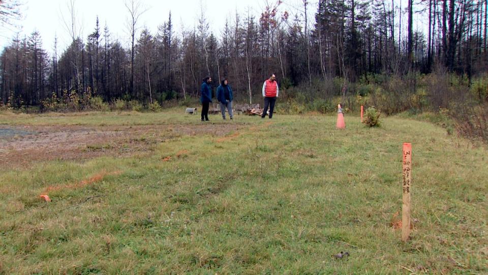 Brandon MacLeod (right) and his sons Connor and Nathan MacLeod walk the property on Yankeetown Road in Hammonds Plains where their home once stood. The house was destroyed in the May wildfire, and they are waiting for their driveway to be repaired before they can rebuild.