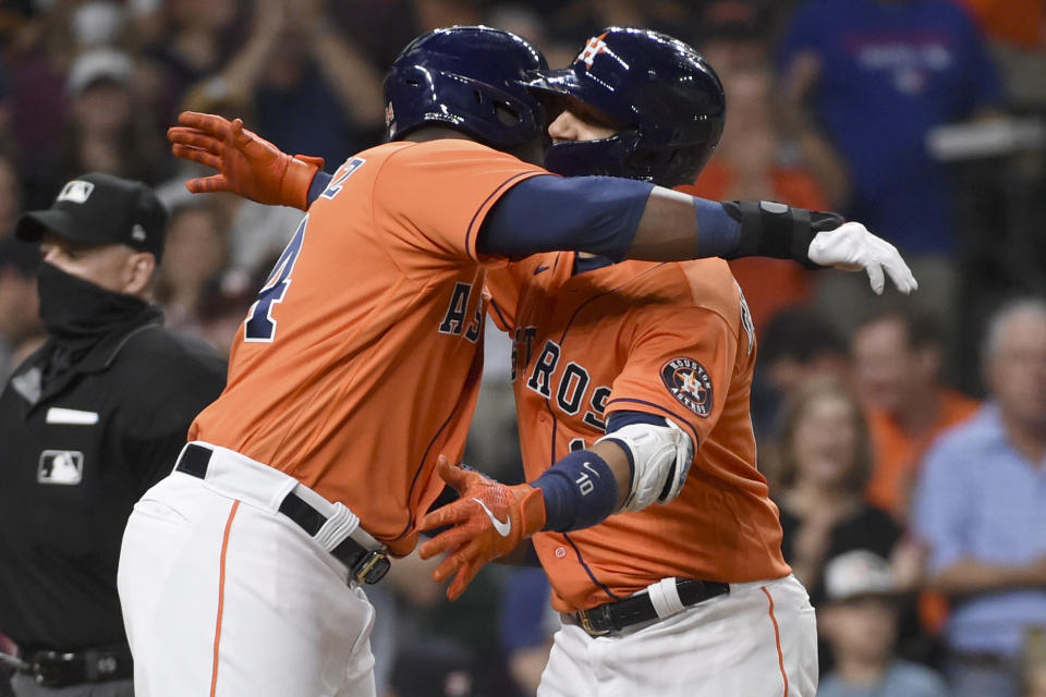 Houston Astros' Yuli Gurriel, right, celebrates his two-run home run with Yordan Alvarez during the fifth inning of baseball game against the Toronto Blue Jays, Friday, May 7, 2021, in Houston. (AP Photo/Eric Christian Smith)