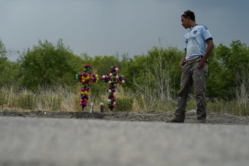 A man pays his respects at the site where officials found dozens of migrants dead in a semitrailer.
