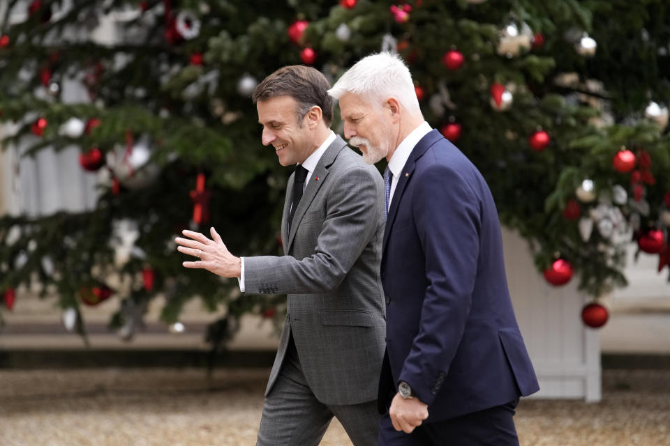 French President Emmanuel Macron, left, welcomes Czech Republic's President Petr Pavel before their talks Wednesday, Dec. 20, 2023 at the Elysee Palace in Paris. (AP Photo/Christophe Ena)