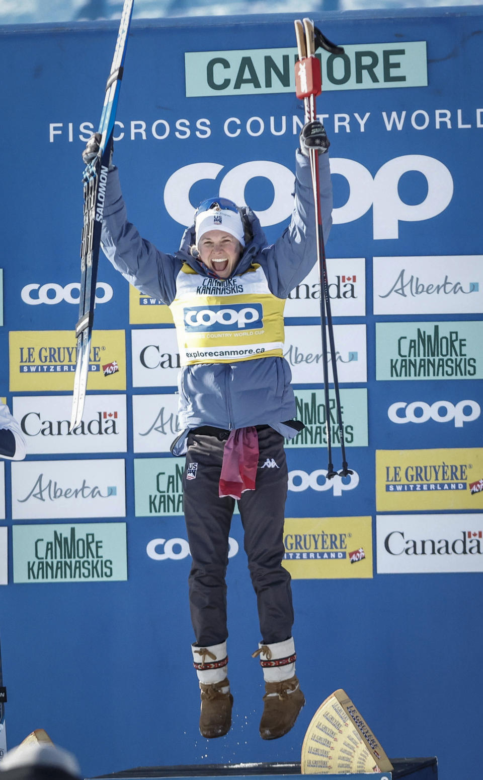 Jessie Diggins, of the United States, celebrates on the podium following her win in the women's 15km Mass Start freestyle World Cup cross country skiing event in Canmore, Alberta, Friday, Feb. 9, 2024. (Jeff McIntosh/The Canadian Press via AP)