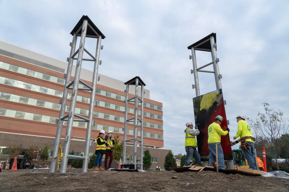 Carpenters for Edward Leske Company install the panels of the Stefan Knapp mural in the courtyard of the of new Valley Hospital in Paramus, NJ on Wednesday Oct. 11, 2023.