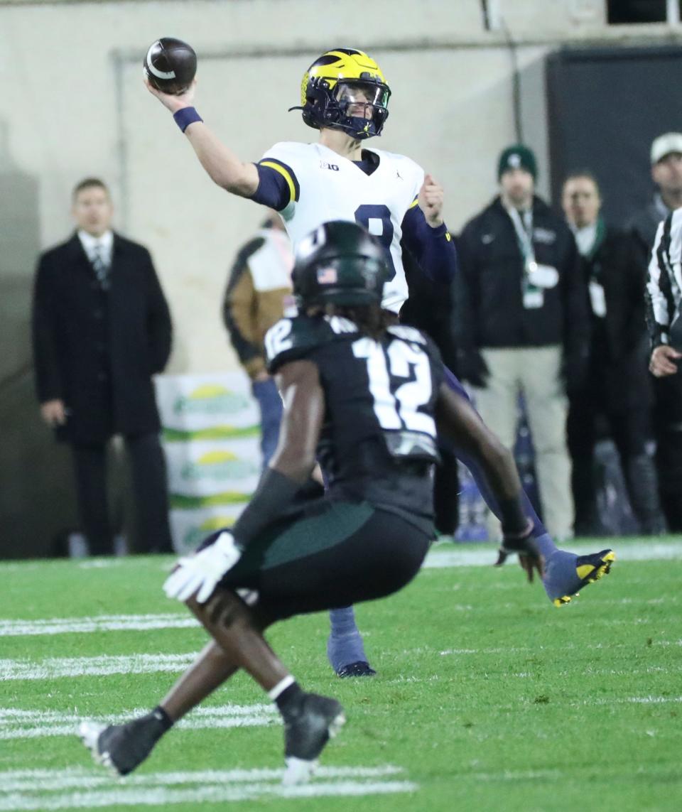 Michigan Wolverines quarterback J.J. McCarthy (9) passes against the Michigan State Spartans during first-half action at Spartan Stadium in East Lansing on Saturday, Oct. 21, 2023.