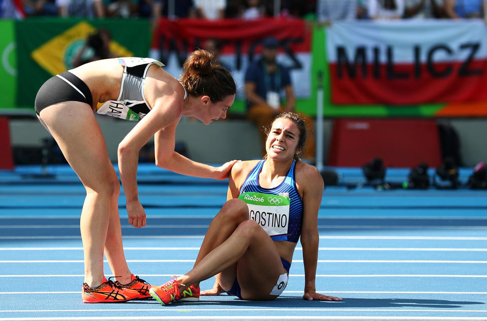<p>Abbey D’Agostino of the United States (R) is assisted by Nikki Hamblin of New Zealand after a collision during the Women’s 5000m Round 1 – Heat 2 on Day 11 of the Rio 2016 Olympic Games at the Olympic Stadium on August 16, 2016 in Rio de Janeiro, Brazil. (Photo by Ian Walton/Getty Images) </p>
