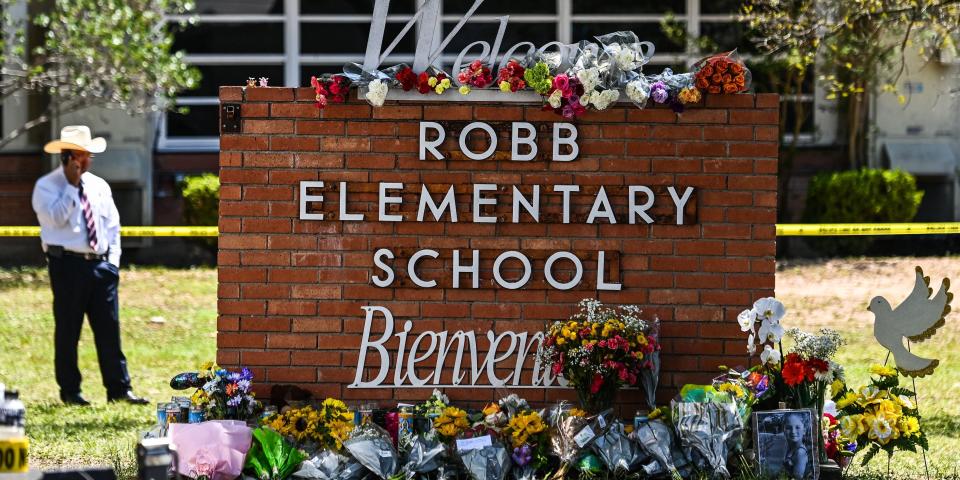 Flowers are placed on a makeshift memorial in front of Robb Elementary School in Uvalde, Texas, on May 25, 2022.