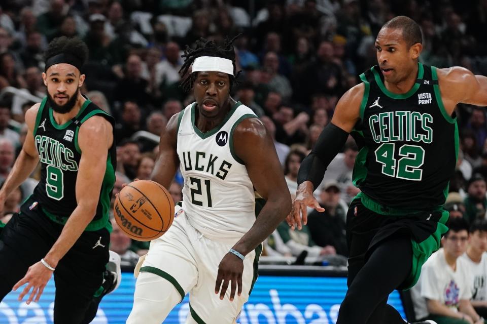 Milwaukee Bucks' Bobby Portis drives past Boston Celtics' Al Horford (42) and Derrick White (9) during the first half of Game 4 of an NBA basketball Eastern Conference semifinals playoff series Monday, May 9, 2022, in Milwaukee. (AP Photo/Morry Gash)