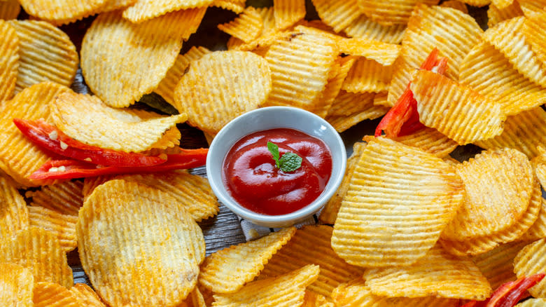 ketchup ramekin surrounded by potato chips