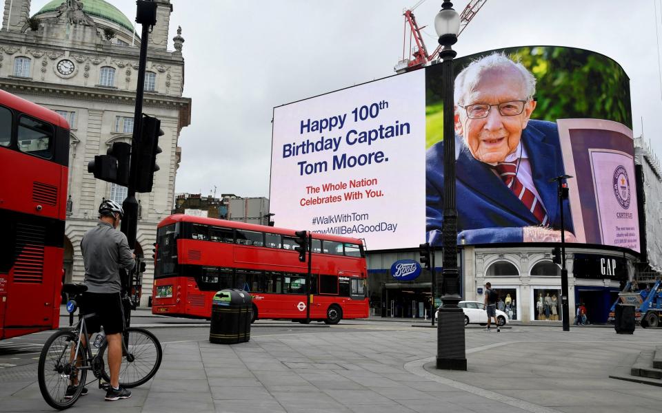 A happy birthday message is displayed on the big screen in Piccadilly Circus for army veteran Captain Tom Moore on his 100th birthday, following the outbreak of the coronavirus disease (COVID-19), in London, Britain, April 30, 2020. REUTERS/Toby Melville/File Photo - Toby Melville/Reuters