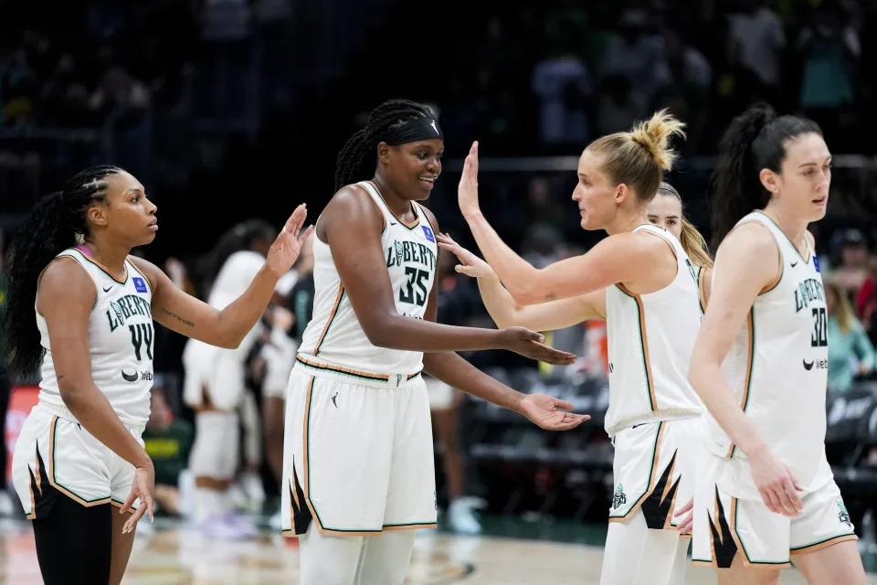 From left, New York Liberty forward Betnijah Laney-Hamilton (44), forward Jonquel Jones (35), forward Leonie Fiebich and forward Breanna Stewart, right, celebrate in the final seconds during the second half of a WNBA basketball game against the Seattle Storm, Friday, Aug. 30, 2024, in Seattle. The Liberty won 98-85. (AP Photo/Lindsey Wasson)