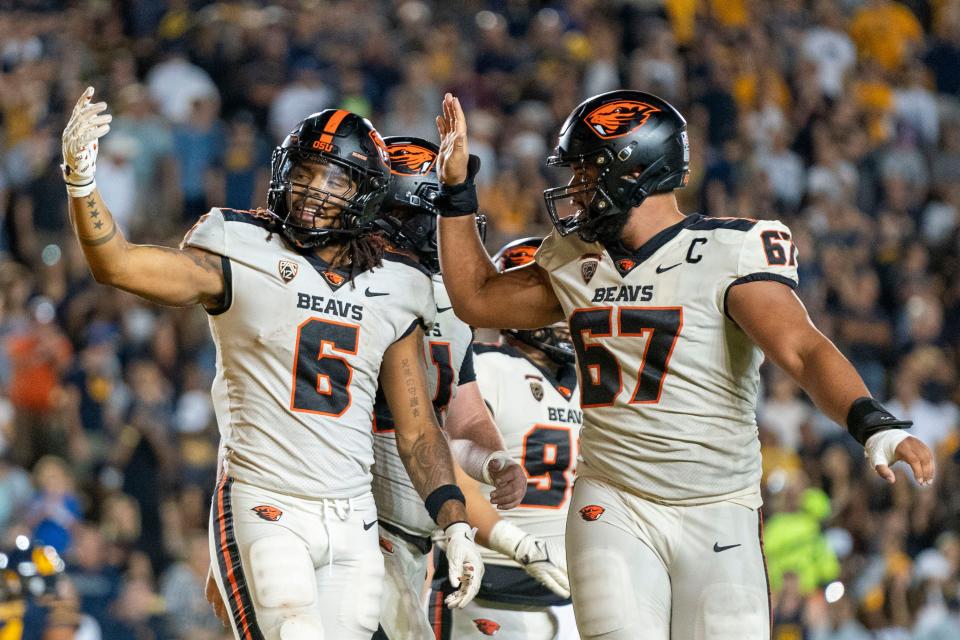Oregon State Beavers running back Damien Martinez (6) is congratulated by offensive lineman Joshua Gray (67) for scoring a touchdown against the California Golden Bears.