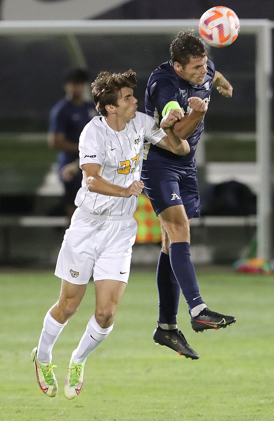 VCU's Nolan Coetzee, left, and University of Akron's Will Jackson go up after a head ball on Monday, Aug. 29, 2022 in Akron, Ohio, at FirstEnergy Stadium.