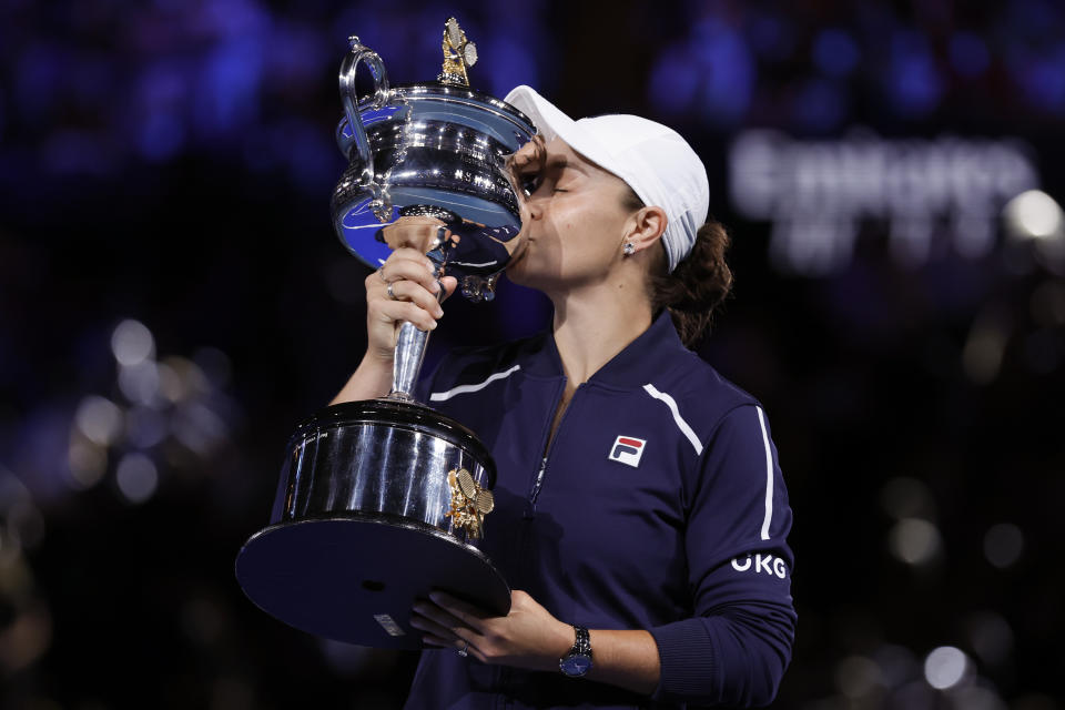 Ash Barty of Australia kisses the Daphne Akhurst Memorial Cup after defeating Danielle Collins of the U.S., in the women's singles final at the Australian Open tennis championships in Saturday, Jan. 29, 2022, in Melbourne, Australia.(AP Photo/Hamish Blair)