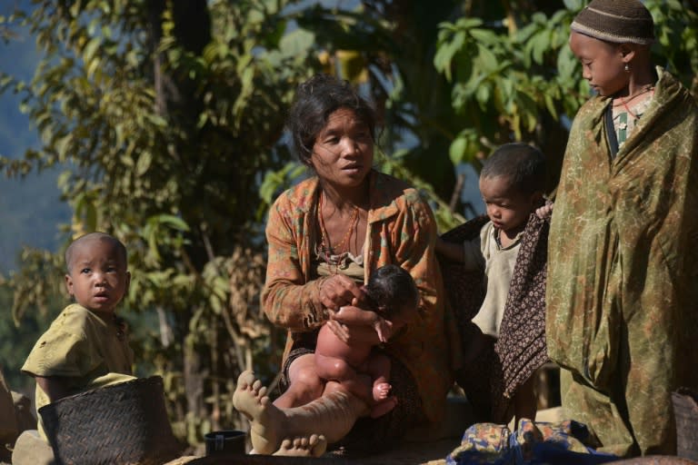 A Naga ethnic woman holds a child in Lahal township in the remote Sagaing region in northern Myanmar