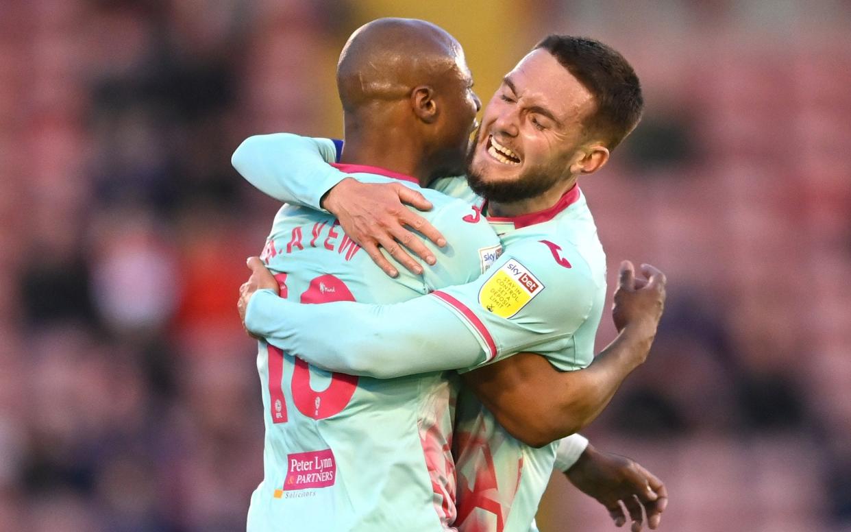 Andre Ayew of Swansea City celebrates with Matt Grimes after scoring his team's first goal during the Sky Bet Championship Play-off Semi Final 1st Leg match between Barnsley and Swansea City - Laurence Griffiths/Getty Images