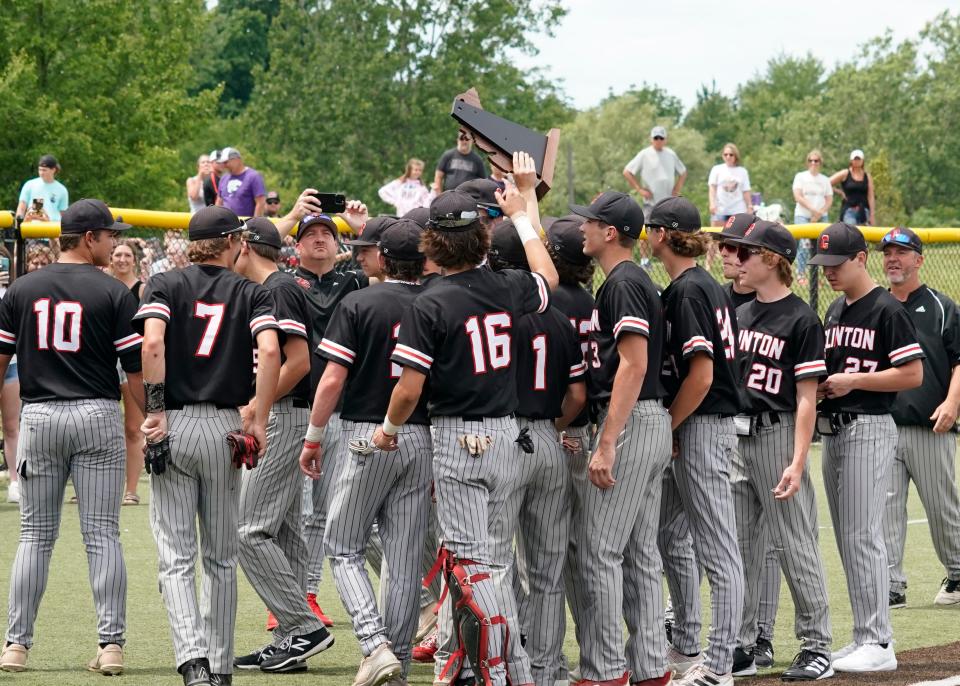 The Clinton baseball team celebrates with the MHSAA Division 3 regional championship trophy Saturday after beating Hudson at Nicolay Field on the campus of Adrian College.
