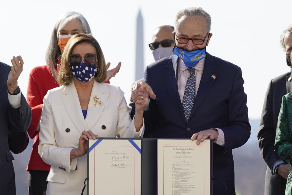 House Speaker Nancy Pelosi of Calif., and Senate Majority Leader Chuck Schumer of N.Y., pose after signing the $1.9 trillion COVID-19 relief bill during an enrollment ceremony on Capitol Hill, Wednesday, March 10, 2021, in Washington. (AP Photo/Alex Brandon)