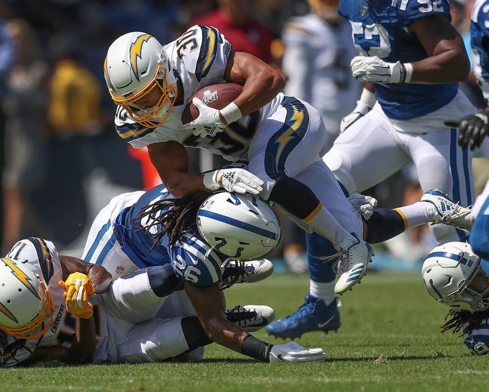 Colts strong safety Clayton Geathers (26) hits Chargers running back Austin Ekeler (30) in 2019.