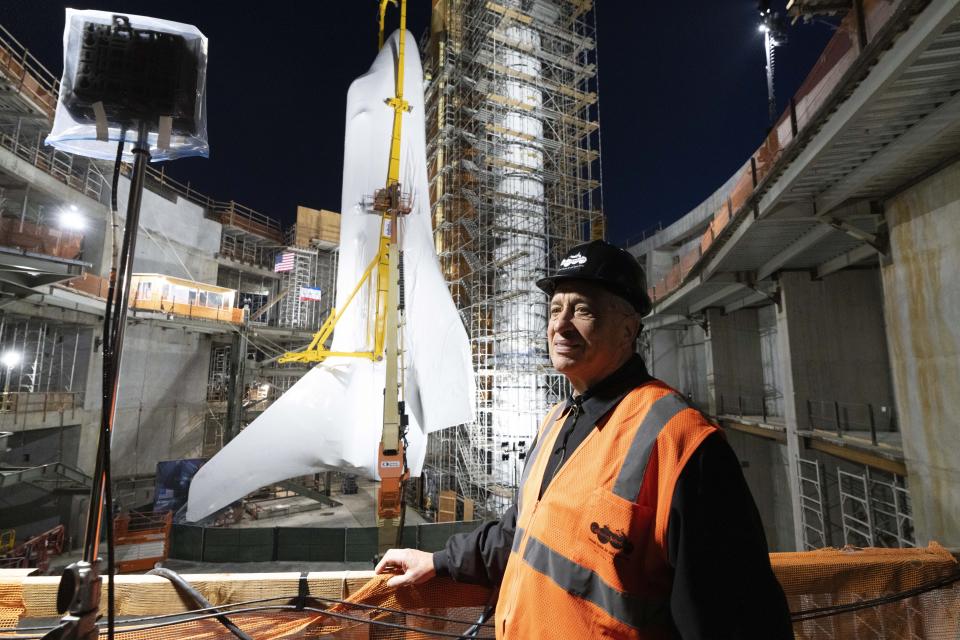 President and CEO of California Science Center Jeffrey Rudolph poses for a photo by the Space Shuttle Endeavour at the site of the future Samuel Oschin Air and Space Center on Tuesday, Jan. 30, 2024, in Los Angeles. NASA's retired Space Shuttle Endeavour was carefully hoisted late Monday to be mated to a huge external fuel tank and its two solid rocket boosters at a Los Angeles museum where it will be uniquely displayed as if it is about to blast off. (AP Photo/Richard Vogel)