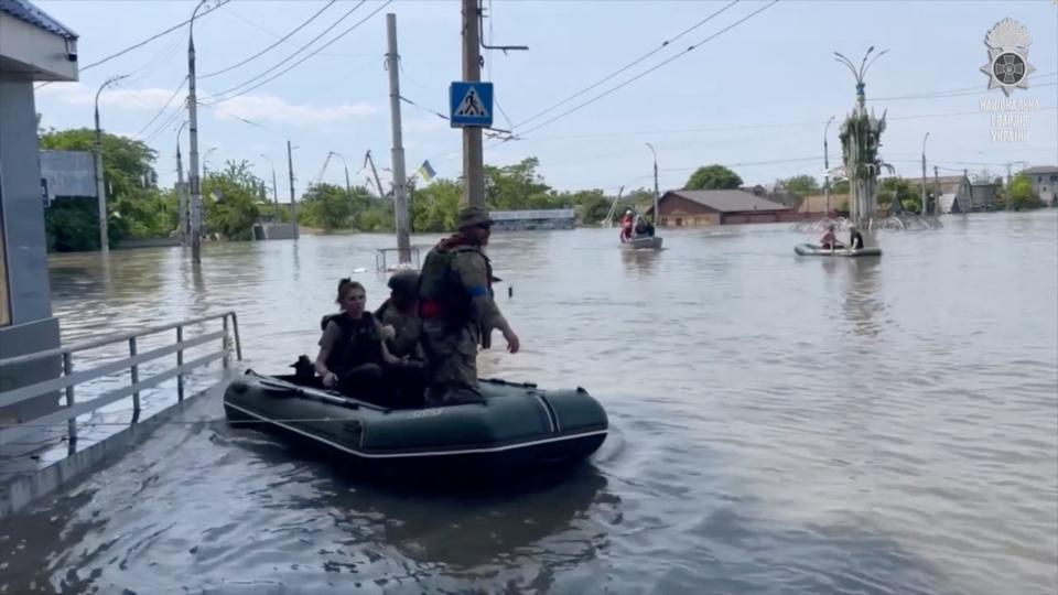 Members of the Ukrainian National Guard take part in an operation to rescue civilians amid flooding in Kherson (via REUTERS)