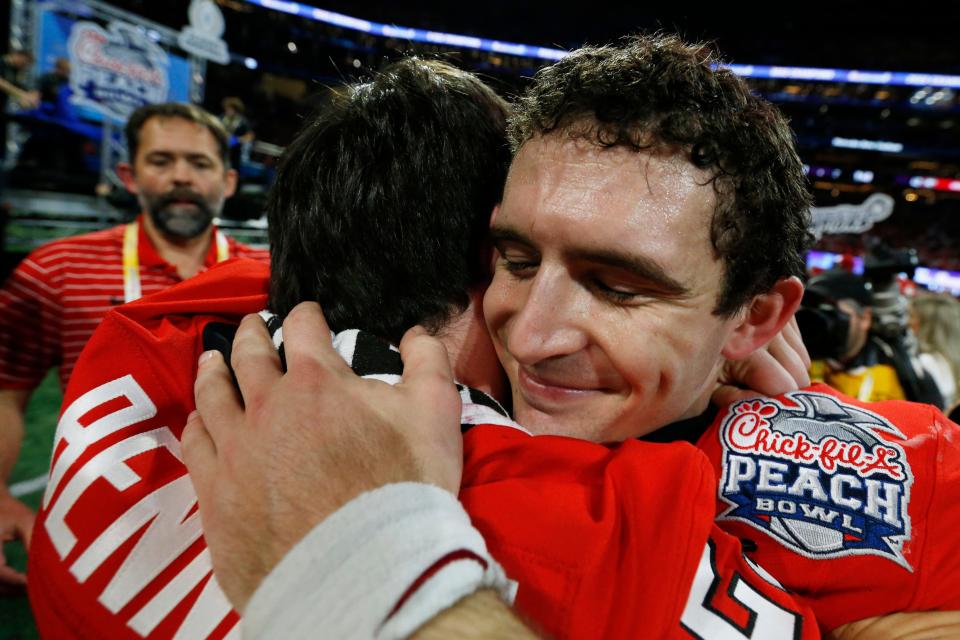 Georgia quarterback Stetson Bennett (13) hugs his brother Georgia walk-on Luke Bennett (29) after the Chick-fil-A Peach Bowl NCAA College Football Playoff semifinal game between Ohio State and Georgia on Sunday, Jan 1, 2022, in Atlanta. Georgia won 42-41.