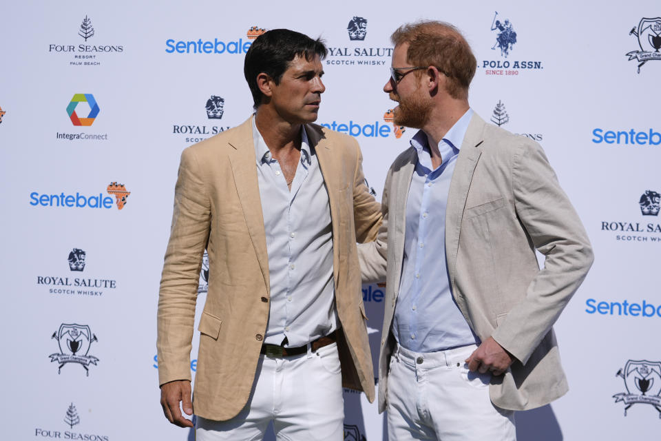 Britain's Prince Harry, right, talks with Argentine professional polo player Ignacio "Nacho" Figueras, as he arrives for the 2024 Royal Salute Polo Challenge to Benefit Sentebale, Friday, April 12, 2024, in Wellington, Fla. Prince Harry, co-founding patron of the Sentebale charity, will play on the Royal Salute Sentebale Team. (AP Photo/Rebecca Blackwell)