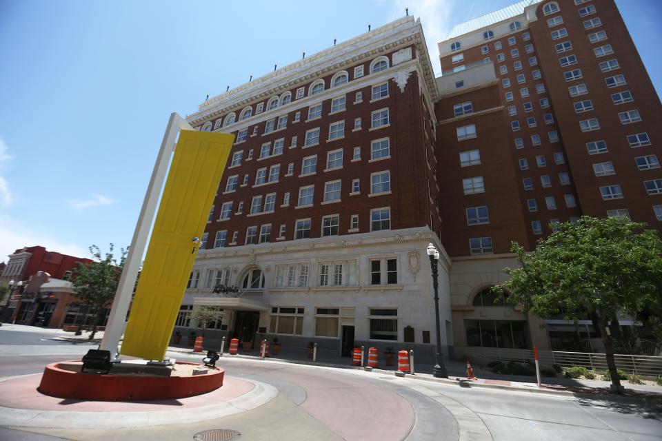 A view of u0022Bienvenido,u0022 the yellow door art installation outside the Paso Del Norte Hotel in El Paso, Texas, in 2021.