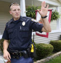 Grand Rapids Police Officer Christopher Schurr stops to talk with a resident, Wednesday, August 12, 2015, in Grand Rapids, Mich. Grand Rapids police have identified Schurr as the officer who killed Patrick Lyoya three weeks ago. Lyoya was a Black man and native of Congo who was fatally shot in the back of the head after a struggle with the officer. Police Chief Eric Winstrom had declined to name the officer but changed course Monday, April 25, 2022. He says he's doing it in the "interest of transparency" and to reduce speculation. (Emily Rose Bennett/The Grand Rapids Press via AP)