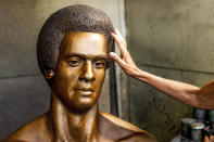Fredrika Newton, widow of Black Panther Party co-founder Huey Newton, touches a bust of her late husband at Artworks Foundry on Tuesday, Aug. 10, 2021, in Berkeley, Calif. The bust is scheduled to be unveiled in Oakland on Sunday, Oct. 24, the first permanent public art piece honoring the party in the city of its founding. (AP Photo/Noah Berger)