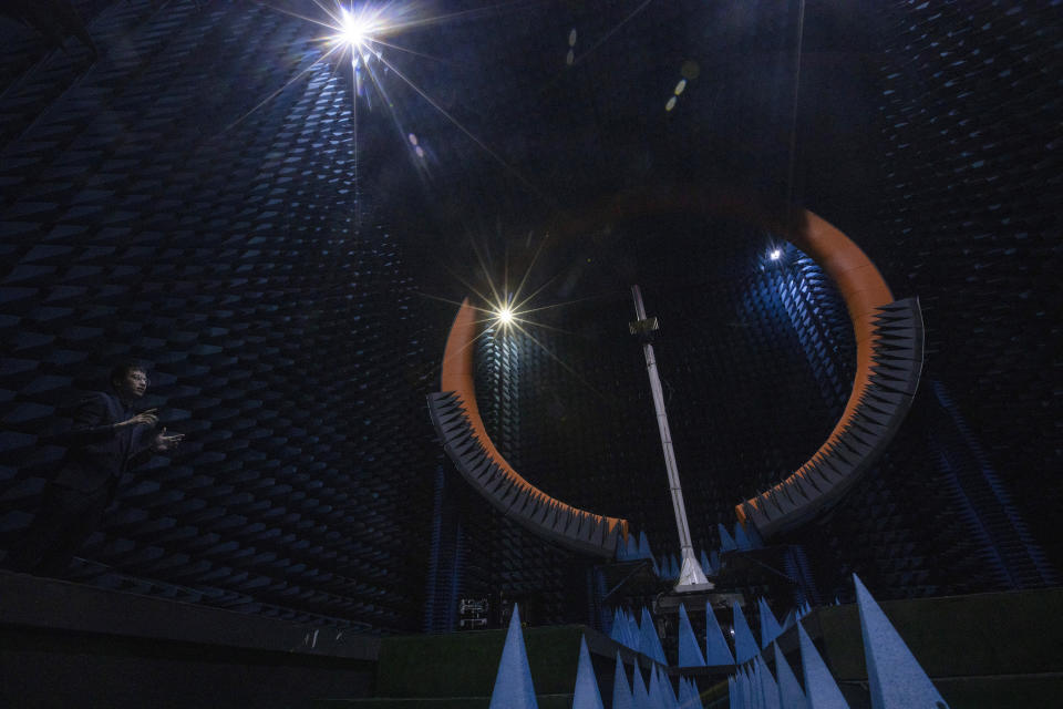 In this Aug. 21, 2019, photo, an engineer describes the function of the Spherical Near Field Test System used for testing antennas at the Huawei lab in Dongguan in Southern China's Guangdong province. Facing a ban on access to U.S. technology, Chinese telecom equipment maker Huawei is showing it increasingly can do without American components and compete with Western industry leaders in pioneering research. (AP Photo/Ng Han Guan)