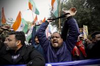 Indian raise their tied hands and shout slogans during a protest against the Citizenship Amendment Act in New Delhi, India, Friday, Dec. 27, 2019. Tens of thousands of protesters have taken to India's streets to call for the revocation of the law, which critics say is the latest effort by Narendra Modi's government to marginalize the country's 200 million Muslims. (AP Photo/Manish Swarup)