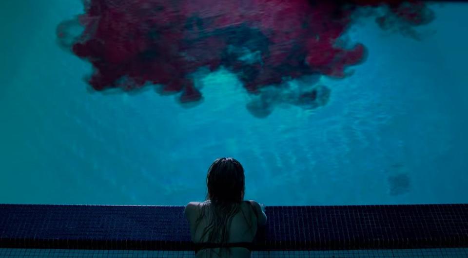 Jay staring at a swimming pool filling with blood in "It Follows"