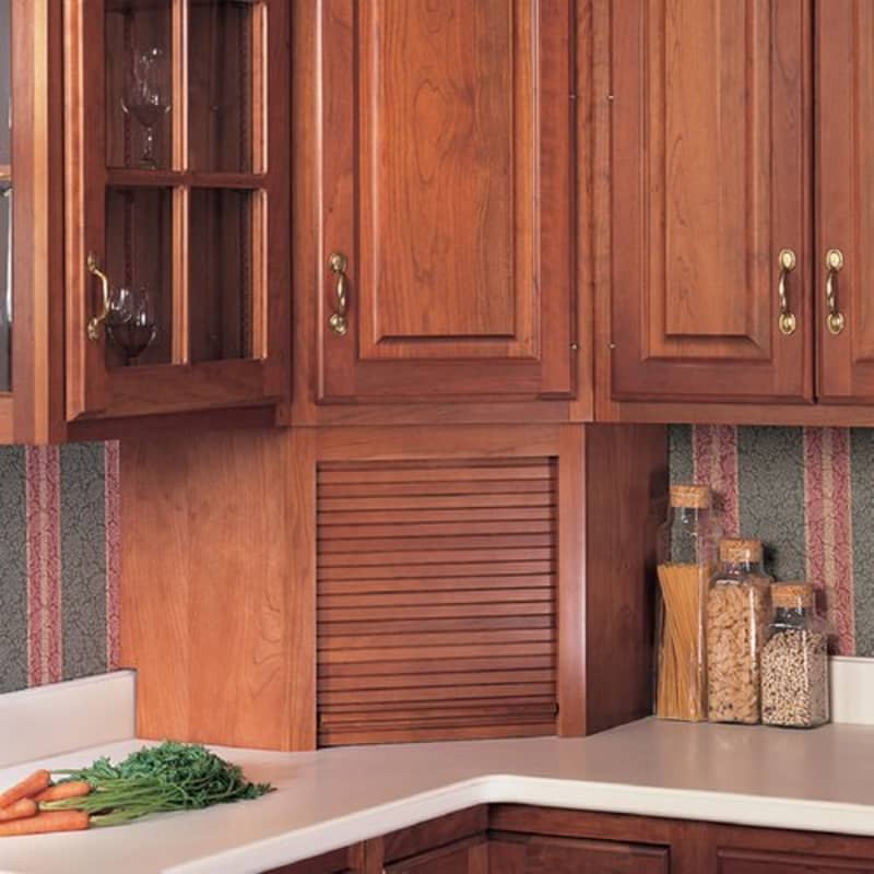 Omega wooden appliance garage with a tambour door in the corner of a kitchen