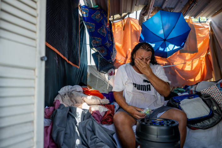 Homeless resident Michael Soes sits in his tent after missing the bus to a cooling center July 14, 2023 in Phoenix, Arizona.  (Brandon Bell/Getty Images)