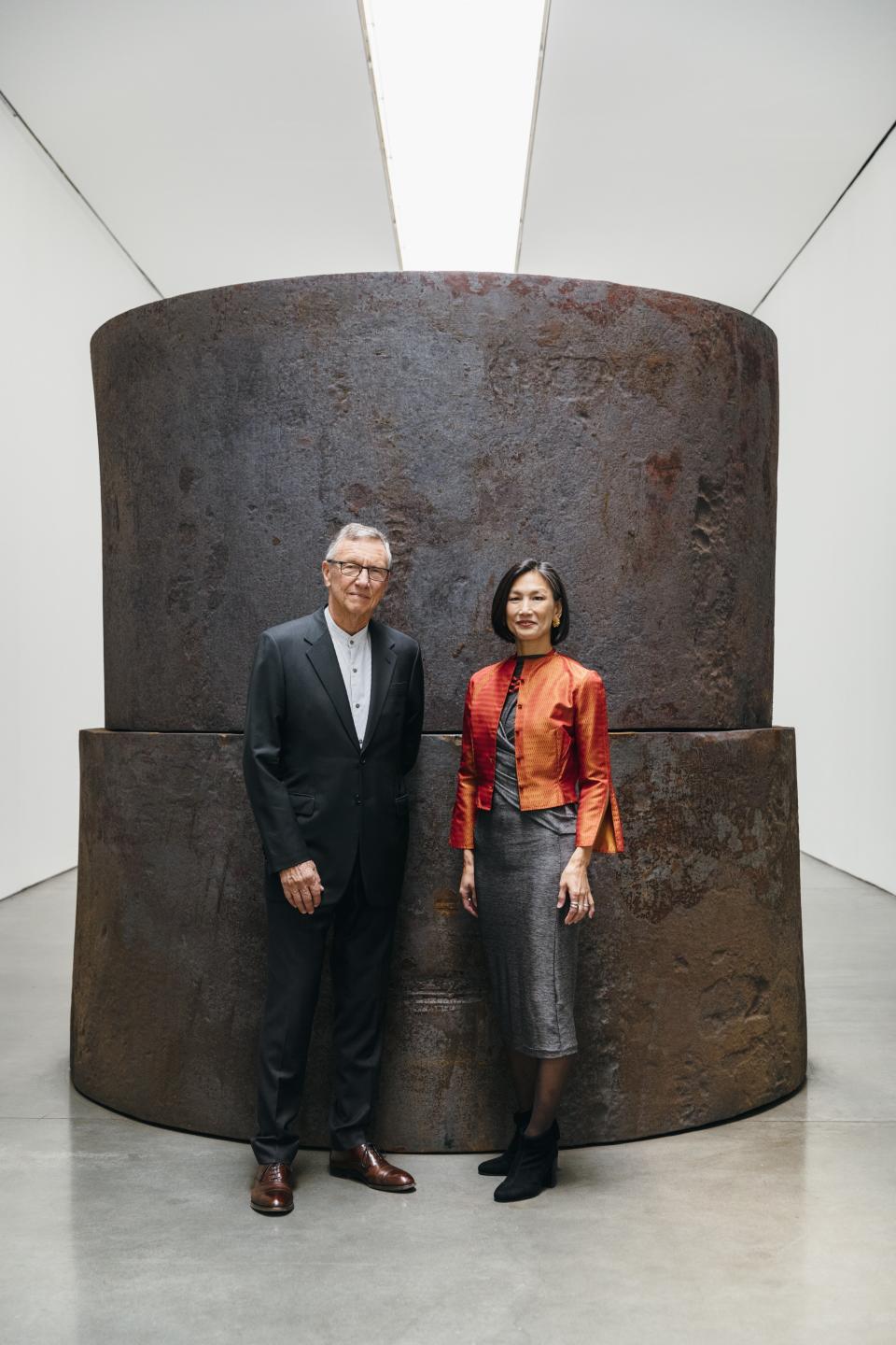 Richard Gluckman (left) and Dana Tang stand in front of a Richard Serra work at Gagosian Gallery in New York, which they designed.