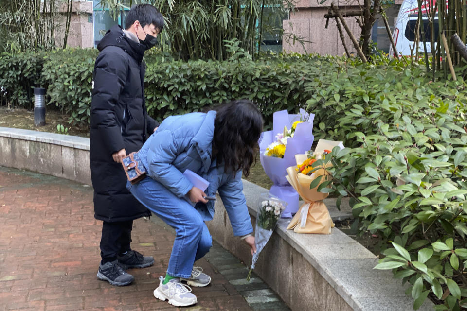 Residents visiting the Wuhan Central Hospital offer flowers in memory of Li Wenliang, the whistleblower doctor who sounded the alarm and was reprimanded by local police for it in the early days of Wuhan's pandemic, prior to the anniversary of his death, in central China's Hubei province, Saturday, Feb. 6, 2021. Dr. Li Wenliang died in the early hours of Feb. 7 from the virus first detected in this Chinese city. A small stream of people marked the anniversary at the hospital. The 34-year-old became a beloved figure and a potent symbol in China after it was revealed that he was one the whistleblowers who authorities had punished early for “spreading rumors” about a SARS-like virus. (AP Photo/Ng Han Guan)