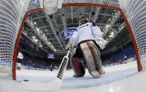 Japan's goalie Nana Fujimoto removes the puck after giving up a goal to Russia's Alexandra Vafina during the third period of their women's ice hockey game at the 2014 Sochi Winter Olympics, February 11, 2014. REUTERS/Mark Blinch/Pool (RUSSIA - Tags: SPORT OLYMPICS SPORT ICE HOCKEY)