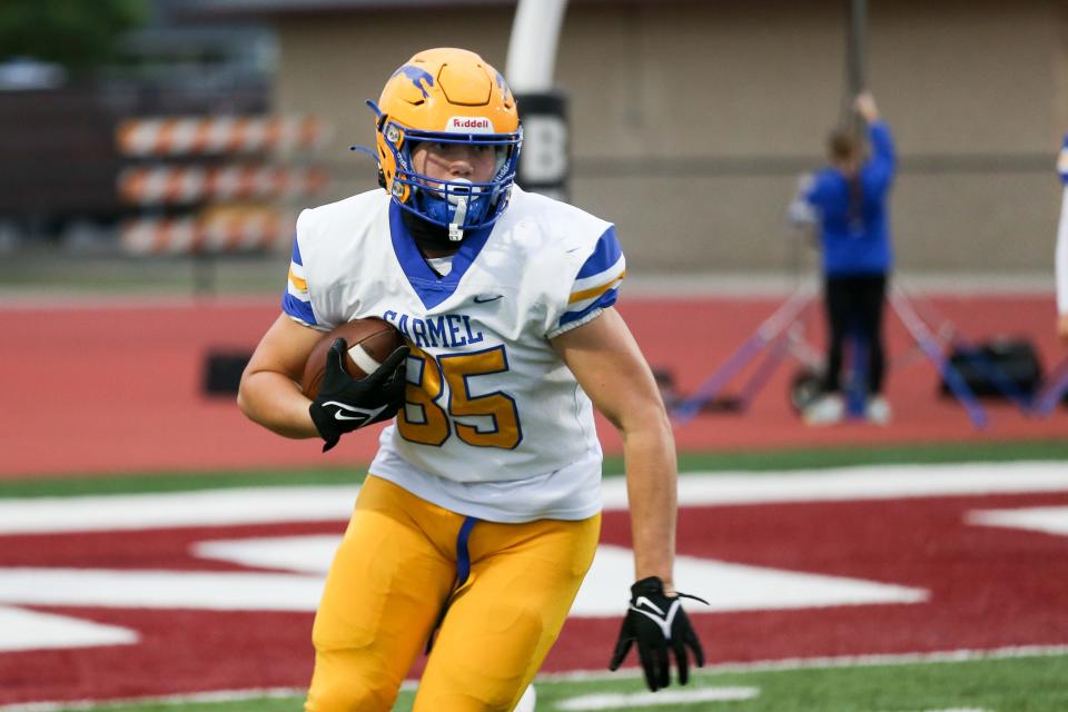 Carmel's Ozzy Pollard (85) warms up prior to the game start during Lawrence Central vs Carmel IHSAA high school football, Oct 13, 2023; Indianapolis, IN, USA; at Lawrence Central High School.