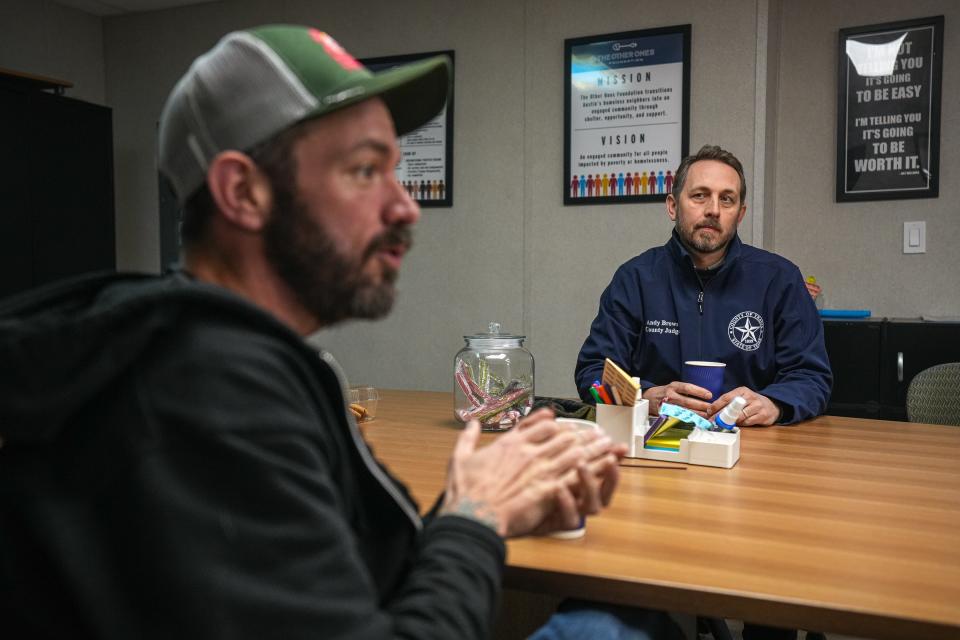 Travis County Judge Andy Brown and the Other Ones Foundation Executive Director Chris Baker take part in a meeting at the Esperanza community.