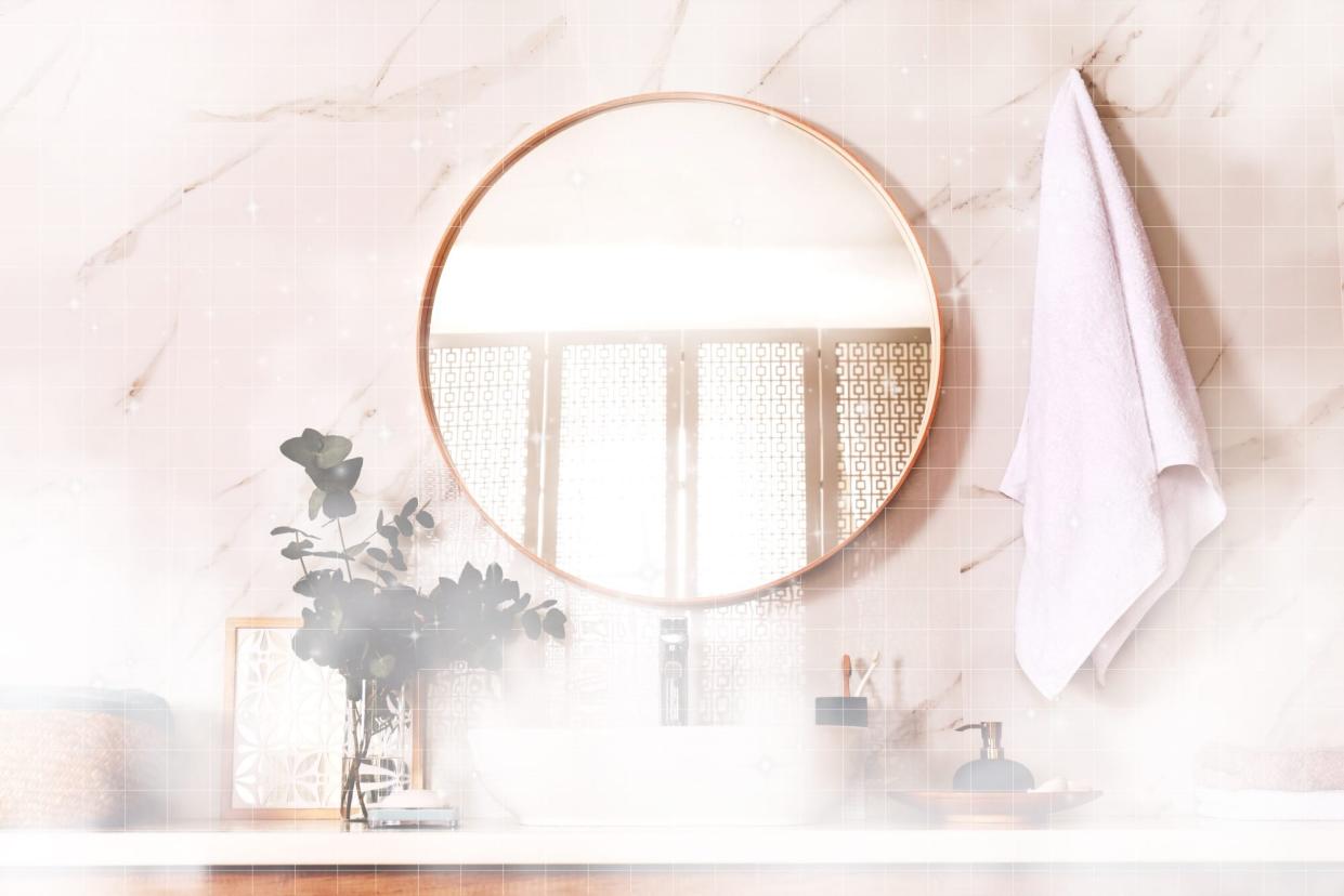 Stylish bathroom interior with vessel sink and round mirror with steam and sparkles overlaid