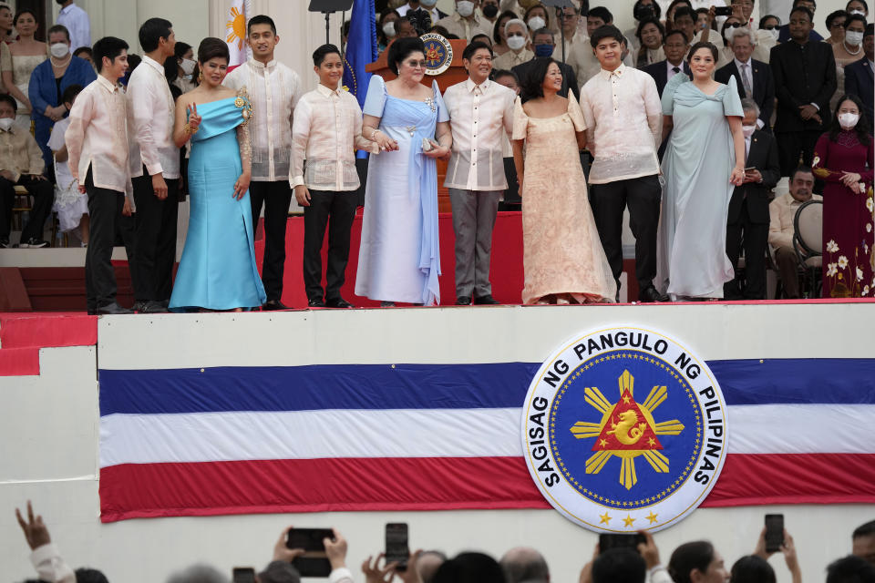 FILE - President-elect Ferdinand "Bongbong" Marcos Jr.,4th from left, poses with his family including his mother Imelda, 5th from left, during the inauguration ceremony on June 30, 2022 at the National Museum in Manila, Philippines. Marcos Jr. has reaffirmed ties with the United States, the first major power he visited since taking office in June, in a key turnaround from the often-hostile demeanor his predecessor displayed toward Manila's treaty ally. (AP Photo/Aaron Favila, File)