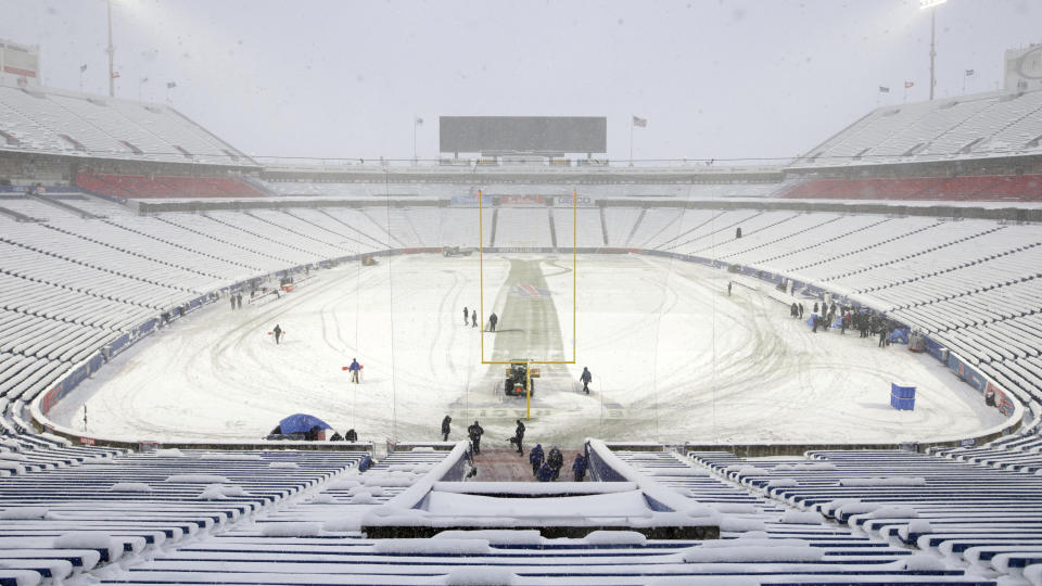 Snow is removed from the field at Highmark Stadium before an NFL football game between the Buffalo Bills and the Miami Dolphins in Orchard Park, N.Y., Saturday, Dec. 17, 2022. (AP Photo/Joshua Bessex)