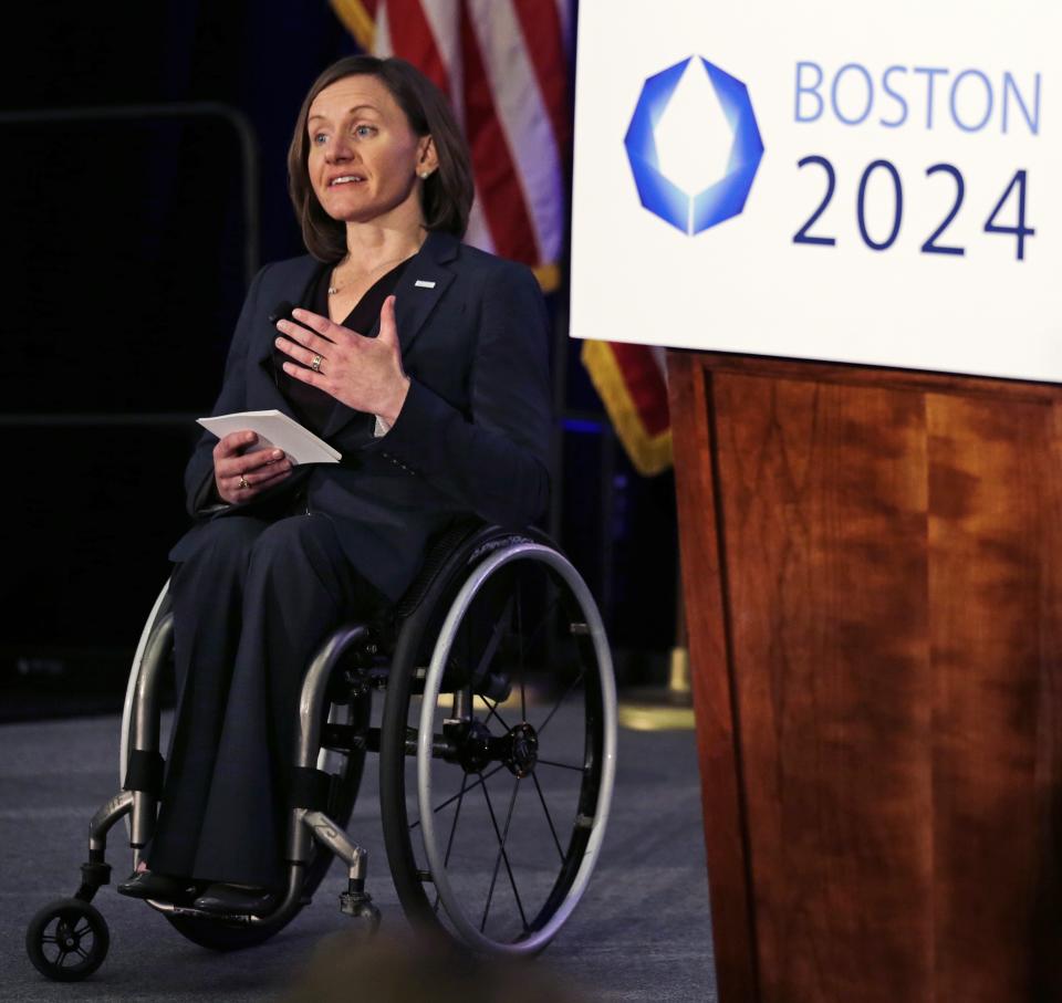 FILE - In this Wednesday, Jan. 21, 2015 file photo, Cheri Blauwet, co-chair of the Boston 2024 Olympic and Paralympic Movement Committee, gestures as she addresses reporters during a news conference by organizers of Boston's campaign for the 2024 Summer Olympics in Boston. Along with the Olympics, the Paralympics have been pushed back to 2021 because of the coronavirus pandemic. The new dates are Aug. 24-Sept. 5. For many Paralympians, a delay seemed like the only option. Paralympic athletes often have specific medical and training needs which can’t always be met at a time when people are staying home and doctors are helping out overloaded ERs. (AP Photo/Charles Krupa, File)