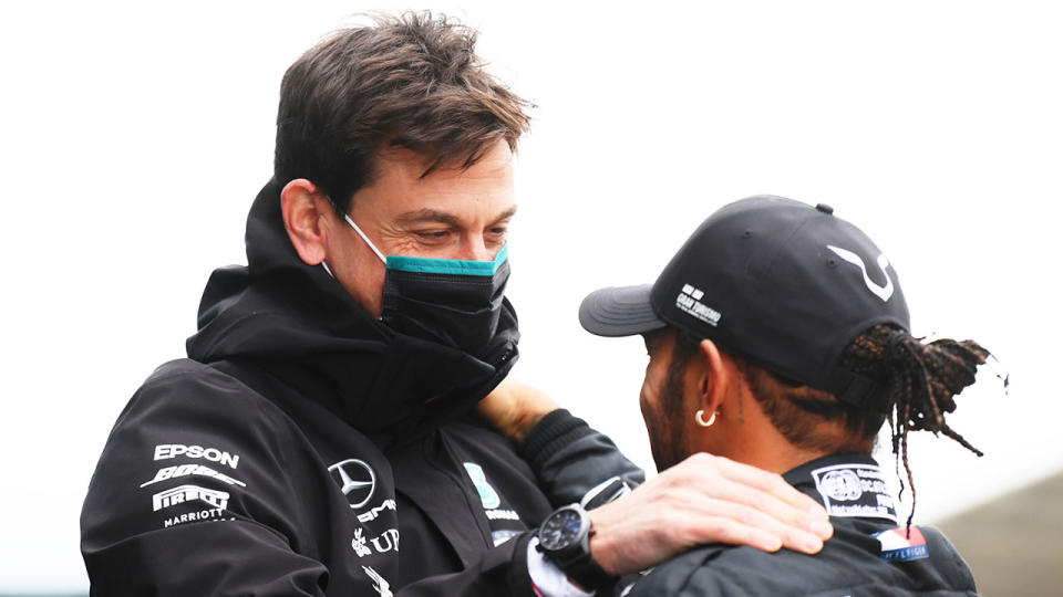 Mercedes team principal Toto Wolff is seen here chatting with driver Lewis Hamilton.