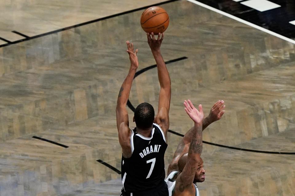 Brooklyn Nets' Kevin Durant (7) shoots over Milwaukee Bucks' P.J. Tucker to tie Game 7 in the second half during a second-round NBA basketball playoff series Saturday, June 19, 2021, in New York. (AP Photo/Frank Franklin II)