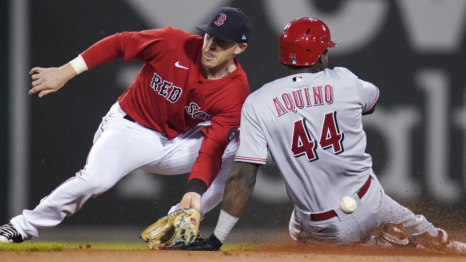 Cincinnati Reds' Aristides Aquino steals second as the ball bounces away from Boston Red Sox second baseman Trevor Story during the sixth inning of a baseball game Wednesday, June 1, 2022, at Fenway Park in Boston. Red Sox catcher Christian Vazquez was charged with a throwing error on the play. (AP Photo/Charles Krupa)