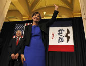 <p>Iowa Lt. Gov. Kim Reynolds waves as she arrives before being sworn in as governor during a ceremonial swearing in, May 24, 2017, at the Statehouse in Des Moines, Iowa. At left is her husband Kevin Reynolds. (Photo: Charlie Neibergall/AP) </p>