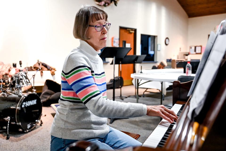 Delta Community Choir pianist Christy English plays during a practice on Monday, April 24, 2023, at St. David's Episcopal Church in Lansing.