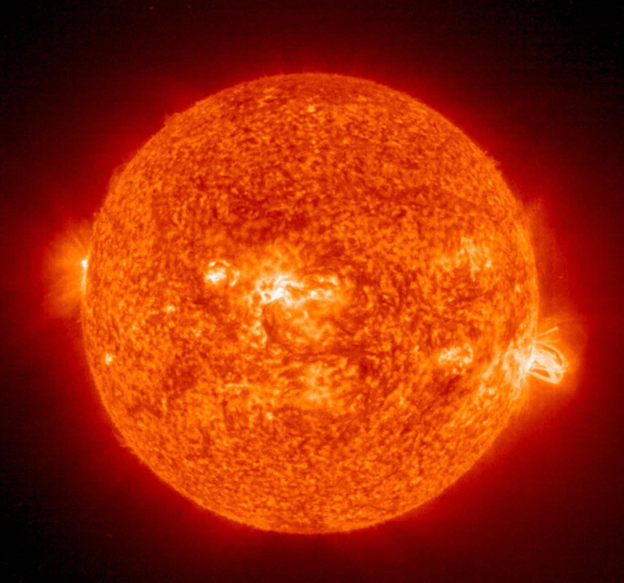 SPACE, SPACE:  This 19 August, 2004 NASA Solar and Heliospheric Administration (SOHO) image shows a solar flare(R) erupting from giant sunspot 649. The powerful explosion hurled a coronal mass ejection(CME) into space, but it was directed toward Earth.  AFP PHOTO/NASA   (Photo credit should read HO/AFP/Getty Images)