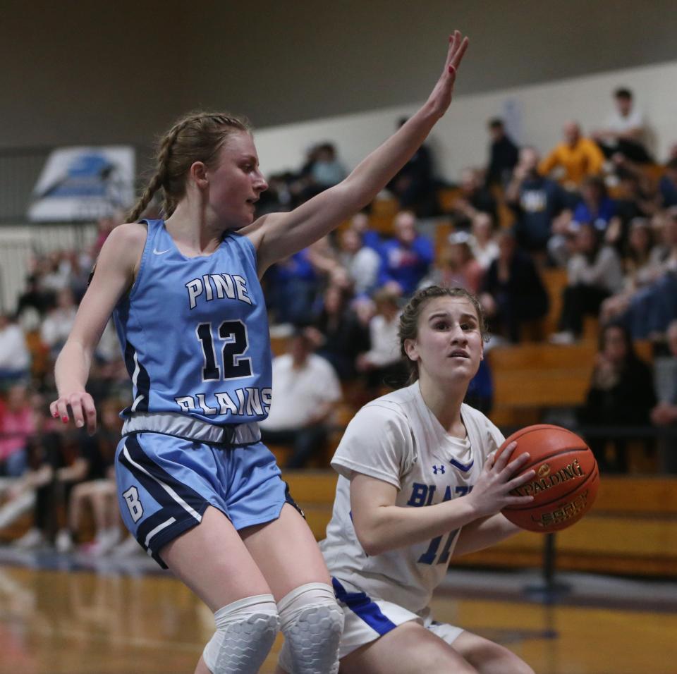 Millbrook's Lilly Kozera looks to clear the ball away from Pine Plains' Michelle Blackburn during the Section 9 Class C girls basketball championship on February 28, 2024.